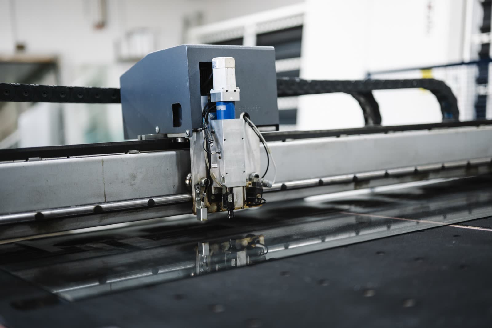 CNC-style cutting machine on a factory production line